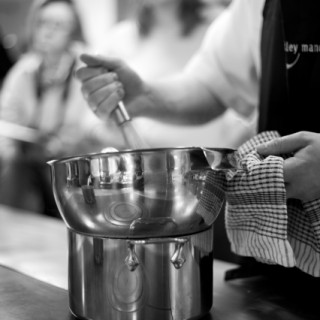 whisking in a bowl over an all clad pan